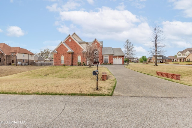traditional-style home with asphalt driveway, a garage, brick siding, and a residential view