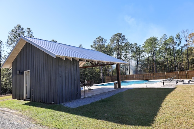 view of swimming pool with a patio area and a yard