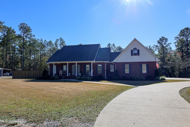 view of front of property with covered porch and a front lawn