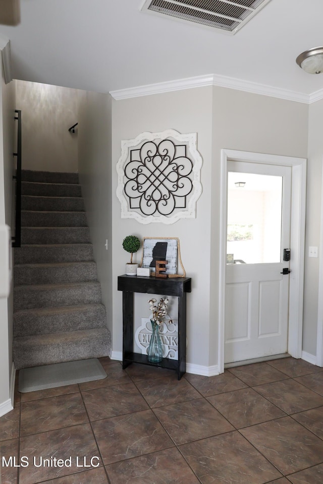 foyer featuring ornamental molding