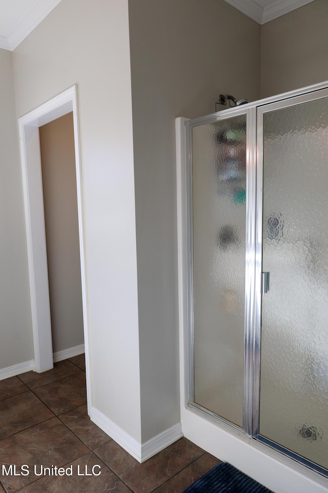 bathroom featuring crown molding and a shower with shower door