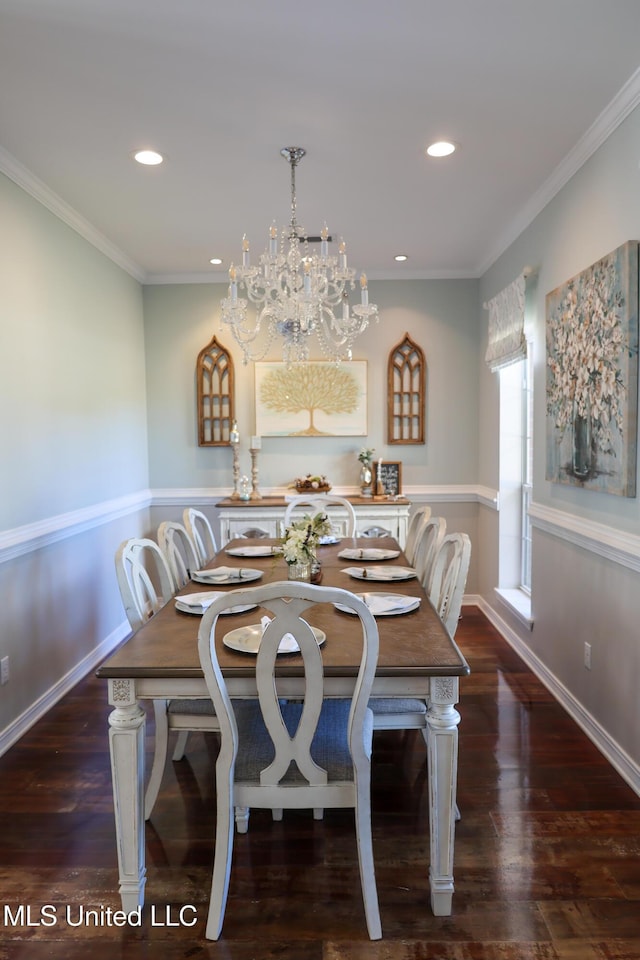 dining room featuring dark hardwood / wood-style floors, ornamental molding, and a chandelier