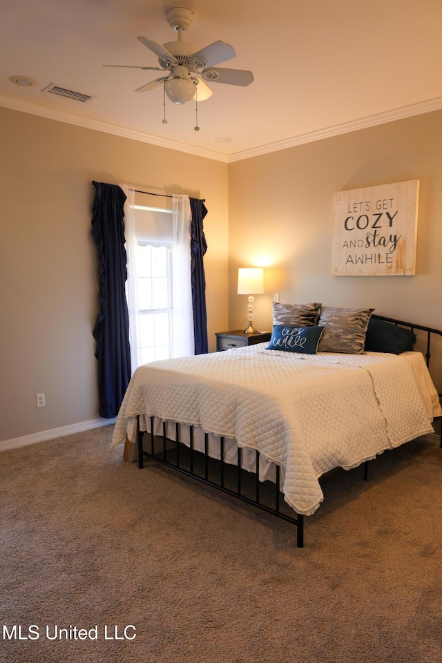 carpeted bedroom with ceiling fan and ornamental molding