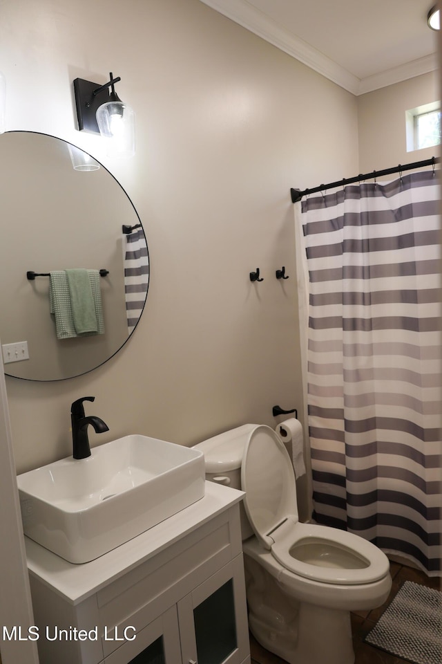 bathroom with toilet, vanity, a shower with shower curtain, and ornamental molding