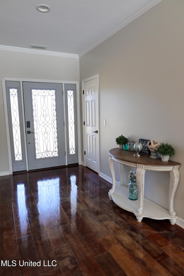 foyer with dark wood-type flooring and crown molding