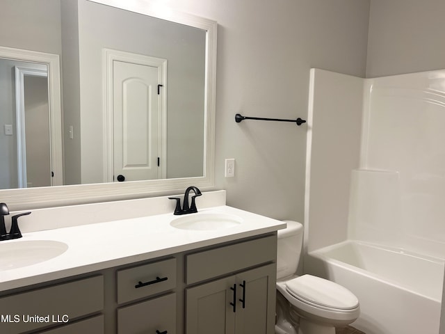 full bathroom with toilet, double vanity, and a sink
