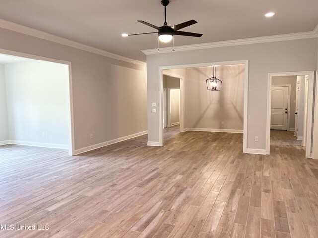 unfurnished living room featuring ornamental molding, light wood finished floors, and ceiling fan