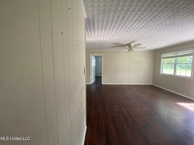 410 N Brooks St, Pelahatchie, MS 39145 - empty room with a ceiling fan and dark wood-style flooring