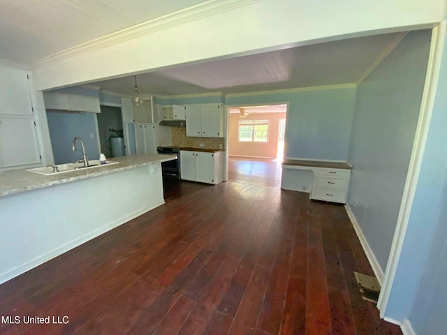 410 N Brooks St, Pelahatchie, MS 39145 - kitchen with ornamental molding, range with electric cooktop, dark wood-type flooring, white cabinetry, and under cabinet range hood