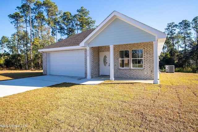 view of front of home with a garage, central air condition unit, and a front yard