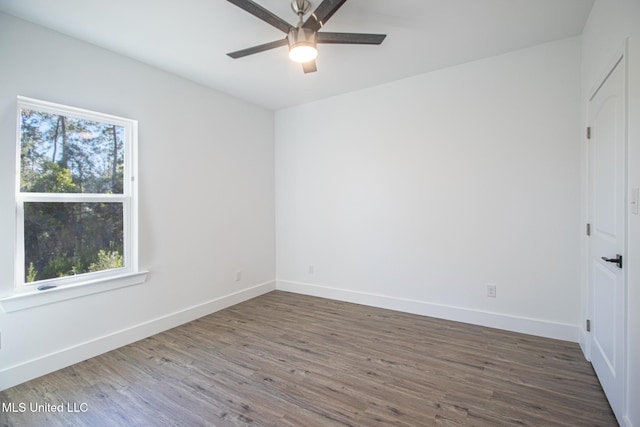 spare room featuring ceiling fan and dark hardwood / wood-style floors