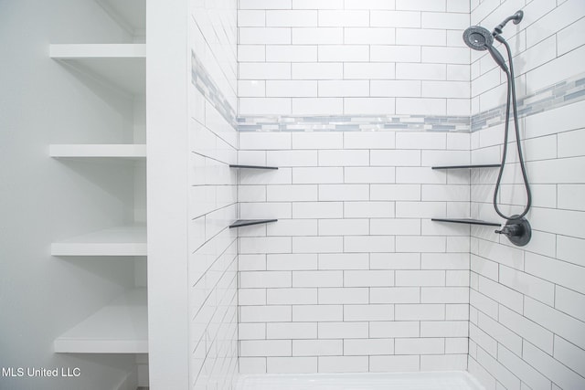 bathroom with tiled shower