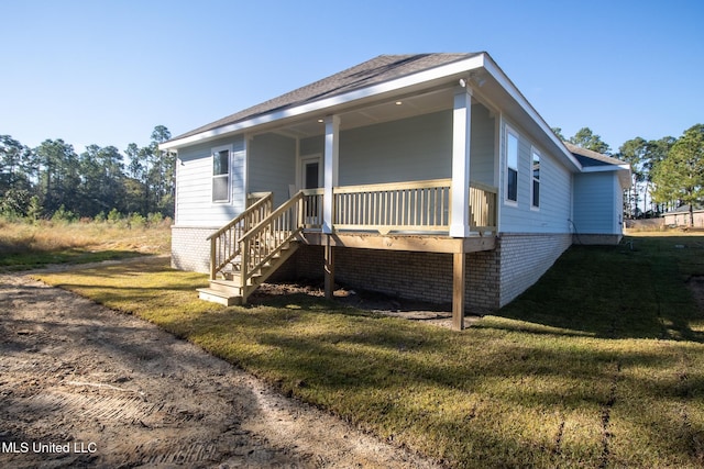 exterior space with a porch and a front yard