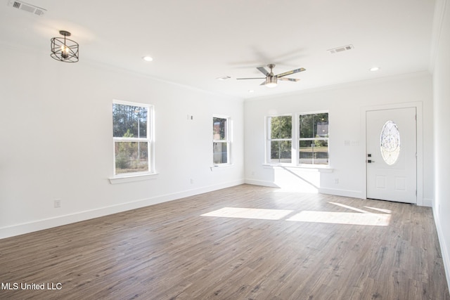 interior space featuring ceiling fan, ornamental molding, and light wood-type flooring