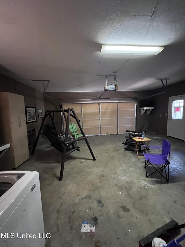 garage featuring washer / dryer and a garage door opener