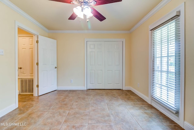 unfurnished bedroom featuring crown molding, light tile patterned floors, visible vents, and multiple windows