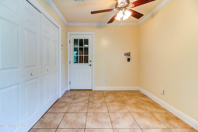 interior space with crown molding, baseboards, ceiling fan, and light tile patterned floors