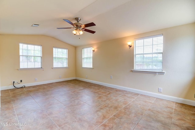 tiled spare room featuring baseboards, visible vents, lofted ceiling, and a ceiling fan