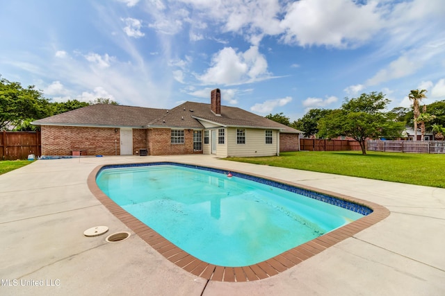 view of swimming pool with a lawn, a patio area, a fenced in pool, and a fenced backyard
