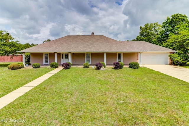 view of front of home with driveway, covered porch, an attached garage, stucco siding, and a front lawn