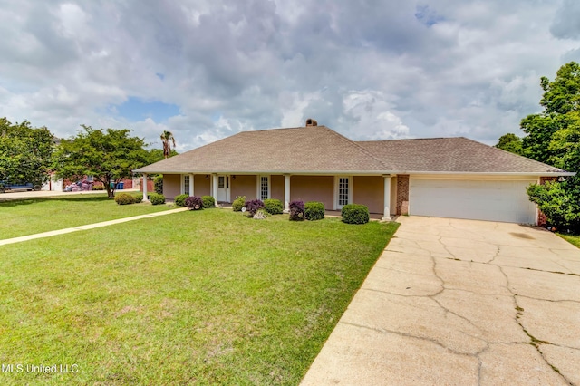 view of front of home featuring a garage, concrete driveway, a shingled roof, a front yard, and a porch