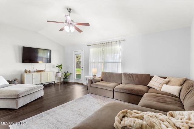 living room featuring ceiling fan, vaulted ceiling, and dark wood-type flooring