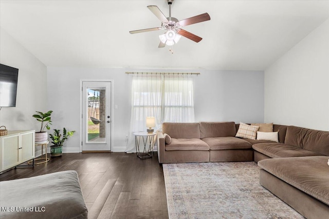 living room with ceiling fan and dark hardwood / wood-style floors