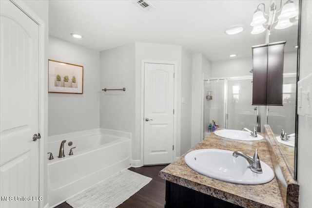 bathroom featuring independent shower and bath, hardwood / wood-style flooring, and vanity