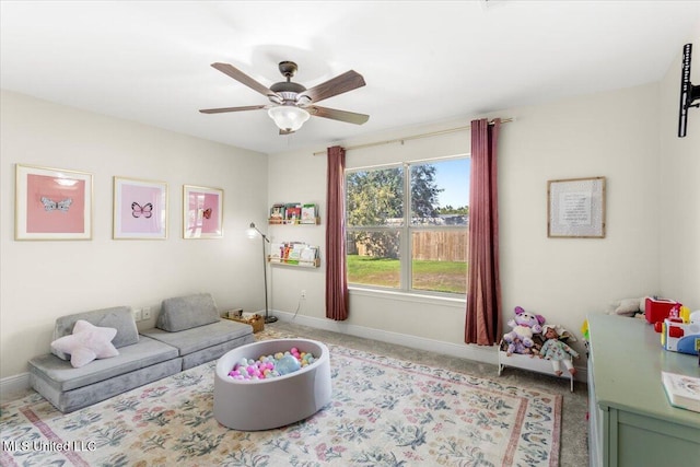 living room featuring ceiling fan and light colored carpet