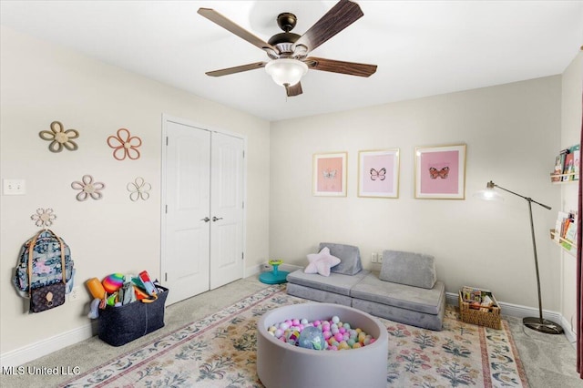 carpeted living room featuring ceiling fan