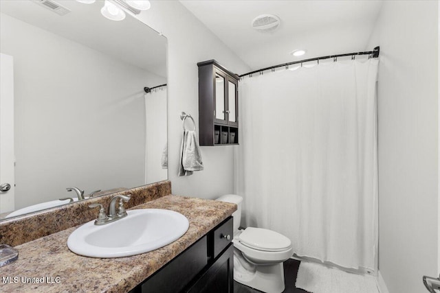 bathroom featuring toilet and vanity