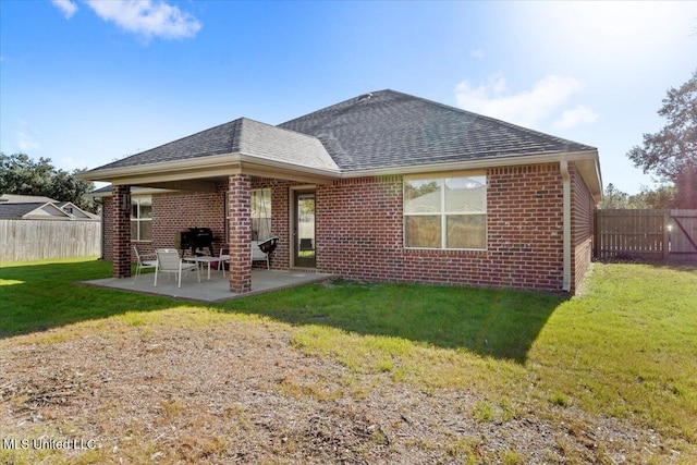 back of property featuring a yard and a patio