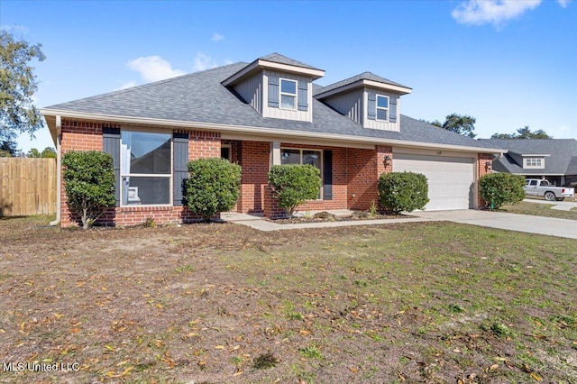 view of front of property with a garage and a front yard