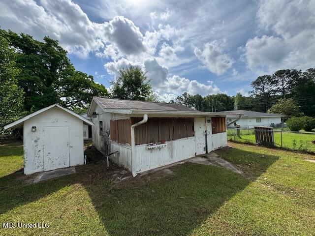 view of shed with fence