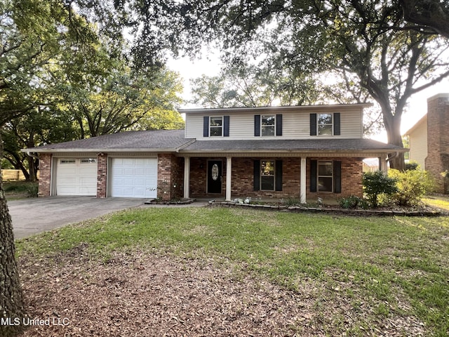1301 Abbeyville St, Pascagoula, MS 39581 - traditional-style house featuring an attached garage, driveway, covered porch, a front yard, and brick siding