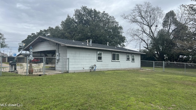 rear view of property with a lawn