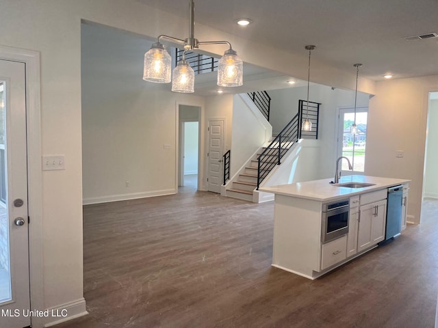 kitchen with dishwasher, a sink, dark wood-style floors, stainless steel microwave, and recessed lighting