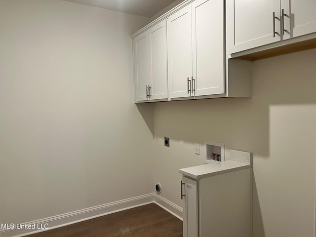 laundry room with cabinet space, electric dryer hookup, hookup for a washing machine, dark wood-type flooring, and baseboards