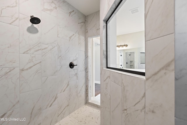 bathroom featuring tiled shower