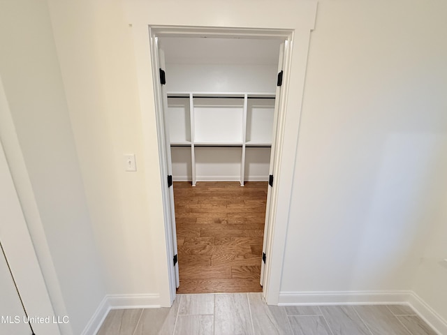 spacious closet with light hardwood / wood-style floors