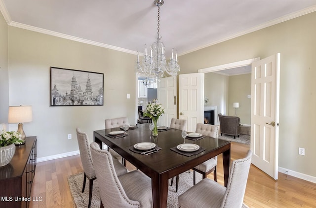 dining room featuring hardwood / wood-style flooring, crown molding, and a chandelier