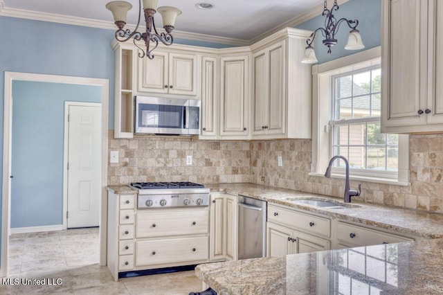 kitchen with hanging light fixtures, appliances with stainless steel finishes, sink, and a notable chandelier