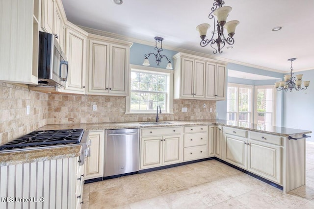 kitchen with sink, a notable chandelier, hanging light fixtures, and appliances with stainless steel finishes