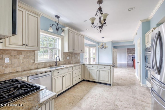 kitchen with pendant lighting, sink, and cream cabinetry