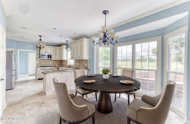 dining space featuring ornamental molding, sink, and a chandelier