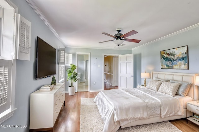 bedroom with hardwood / wood-style floors, ornamental molding, connected bathroom, and ceiling fan