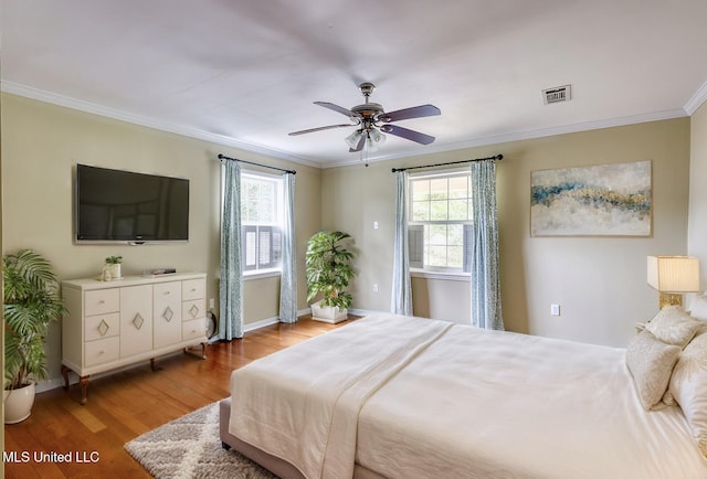 bedroom featuring ornamental molding, ceiling fan, and light hardwood / wood-style floors