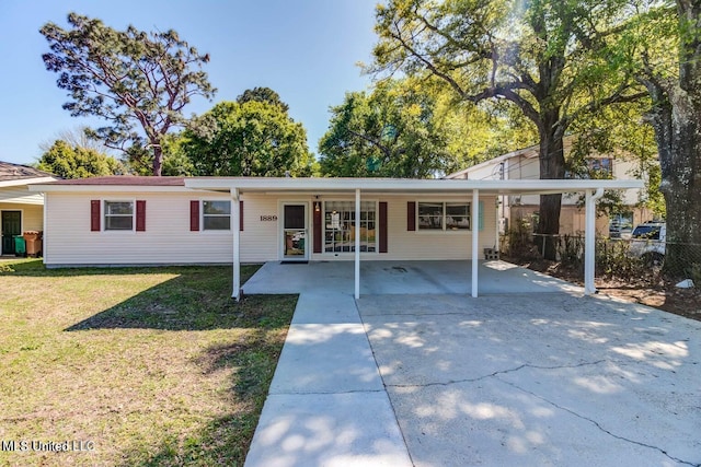 single story home with concrete driveway, fence, a front yard, and an attached carport