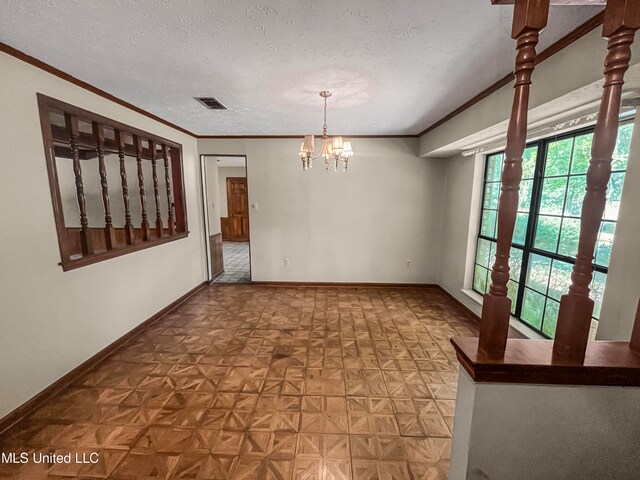 unfurnished room with ornamental molding, a chandelier, a textured ceiling, and parquet floors