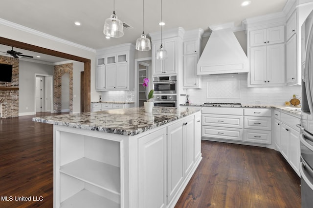 kitchen featuring visible vents, open floor plan, custom range hood, white cabinetry, and open shelves